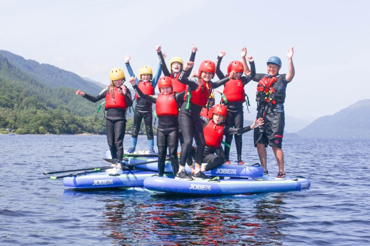 a group of people riding skis on a body of water