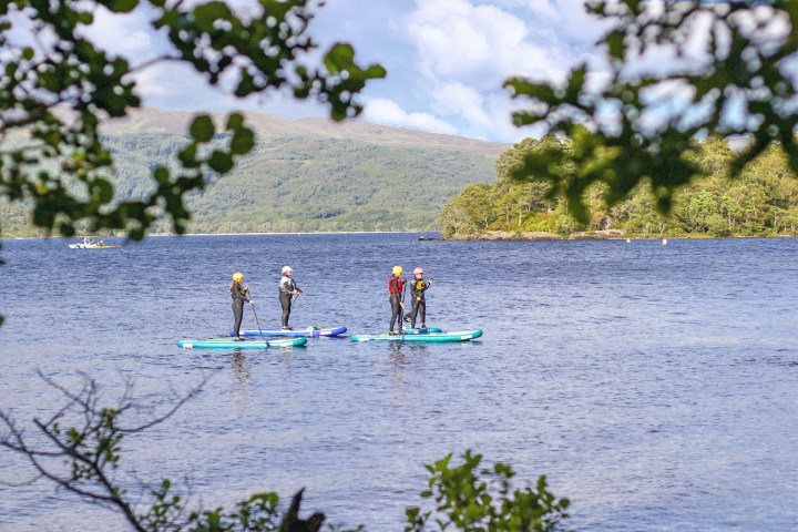 a group of people riding skis on a body of water